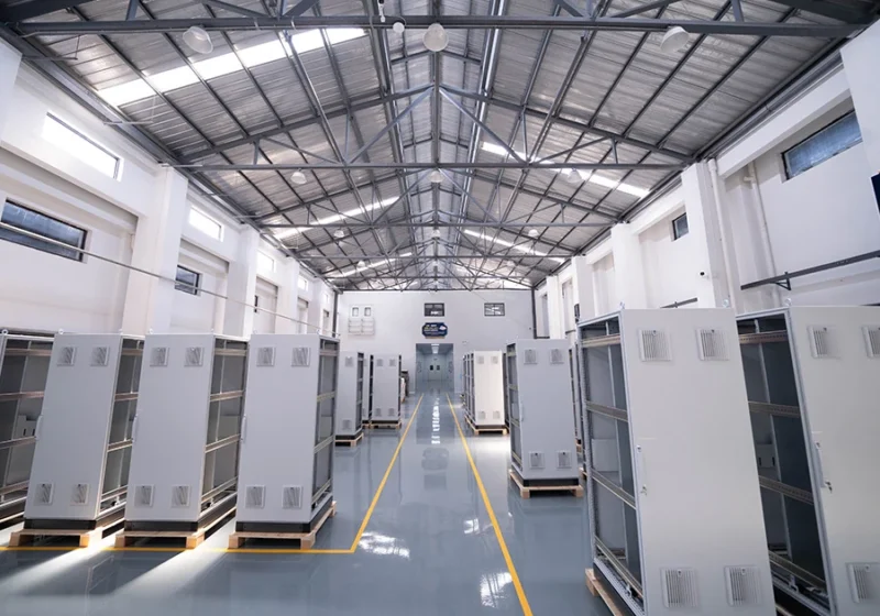 ADMS cabinet manufacturing hall with rows of finished enclosures